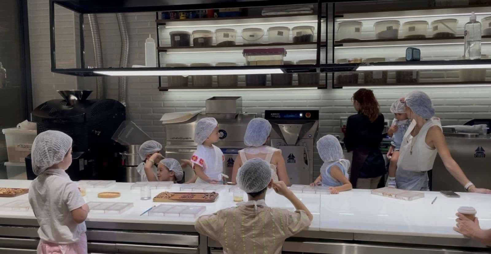 School group watching chocolate making in the Maison Choc kitchen